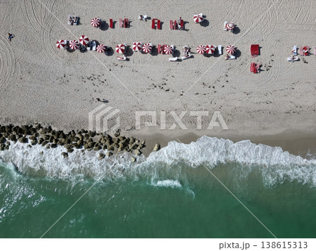 Summer vacation in paradise. Beach vacation at sea in summer. Sea relax under beach umbrella. Travel to sea. Aerial top view of sand beach with crystal clear turquoise water. Enjoying beach sun 138615313