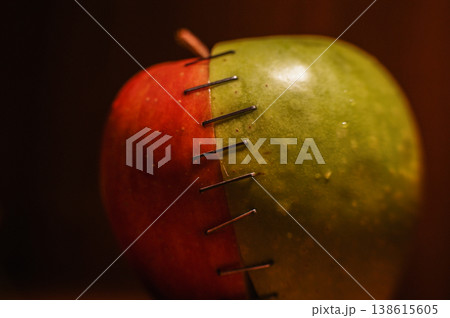 green and red apple stapled with two halves 138615605