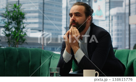 Worried hopeless businessman working under pressure in despair, struggling with corporate downfall and battling the stress of a financial crisis. Business failure and problems. Camera B. 138615776
