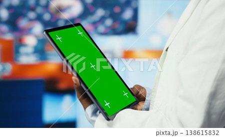 Scientist reviewing medical scans using green screen tablet, 360 degrees rotation. Woman in front of digital health dashboards backdrop analyzing human anatomy with mockup device, camera B close up Scientist reviewing medical scans using green screen tablet, 360 degrees rotation. Woman in front of digital health dashboards backdrop analyzing human anatomy with mockup device, camera B close up 138615832