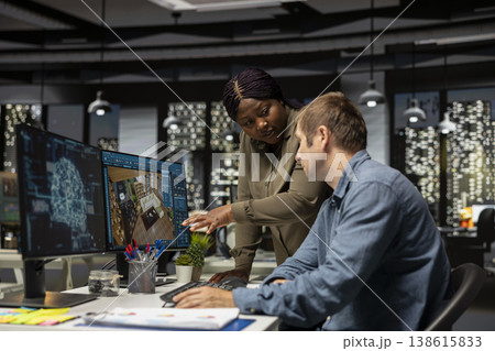 Diverse team of engineers using artificial intelligence to design a floor plan, working together with neural networks and computer aided apartment layout on architectural software. 138615833