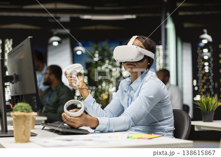 Female office worker using VR headset with artificial intelligence after hours, working hard with virtual reality tech to ensure tasks completion and forecasting projections. 3D simulation. 138615867