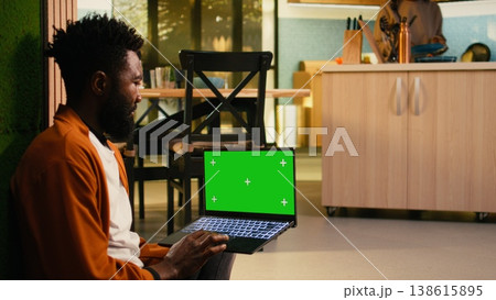 Isolated chroma key with African American man in soft light warm interior, peaceful domestic life capturing relaxation and comfort. Modern lifestyle sitting on the floor in hallway, ambiance. 138615895