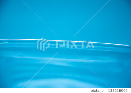 Smooth blue water surface with soft reflections, minimal liquid texture, clean abstract background, purity and freshness concept. 138616063