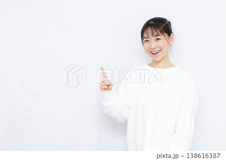 人差し指を立てる女性 138616387