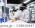 Researcher using computer and VR headset gear for DNA data analysis in laboratory. Research facility specialist using bioinformatics genomics software and virtual reality tech in modern lab 138616447