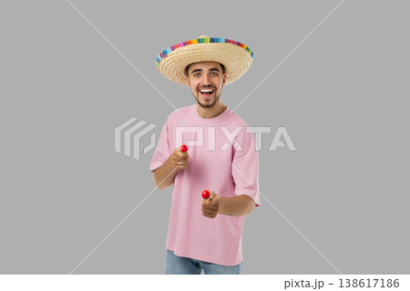 Cinco de Mayo, Young man in sombrero plays maracas in celebration 138617186