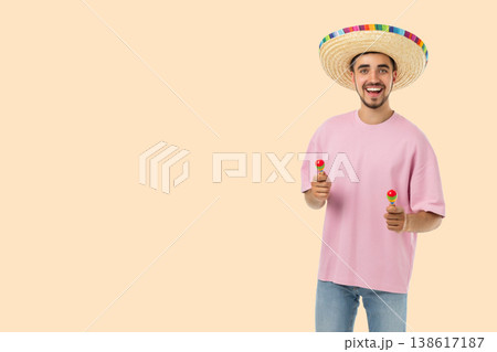 Cinco de Mayo, Young man in sombrero smiles with maracas Cinco de Mayo, Young man in sombrero smiles with maracas 138617187