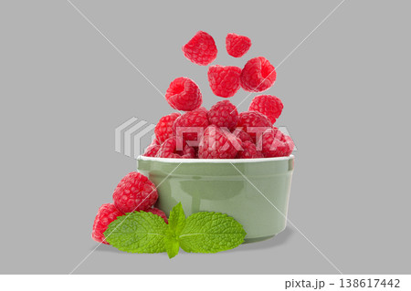 Raspberries in a bowl with mint leaves and some floating Raspberries in a bowl with mint leaves and some floating 138617442
