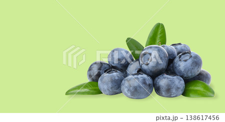 Fresh blueberries with green leaves stacked together Fresh blueberries with green leaves stacked together 138617456