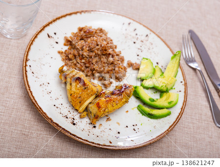 Tender meat of fried chicken meat is garnished with boiled buckwheat 138621247