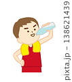 首にタオルを巻いて腰に手を当て、笑顔で水分補給をする少年2(上半身) 138621439