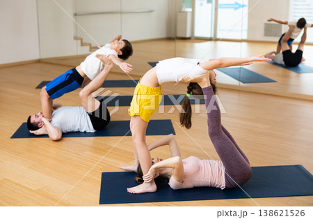 Kids and parents doing stretching exercises during yoga training Kids and parents doing stretching exercises during yoga training 138621526
