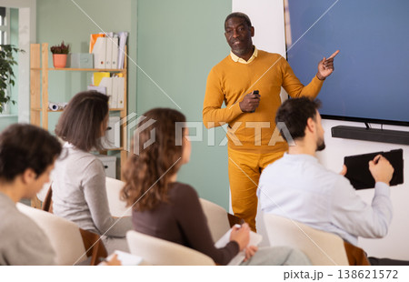 During lesson, African man teacher tells material and gives lecture 138621572