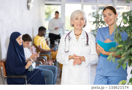 Portrait of an experienced female doctor and a young nurse in medical clinic Portrait of an experienced female doctor and a young nurse in medical clinic 138621574