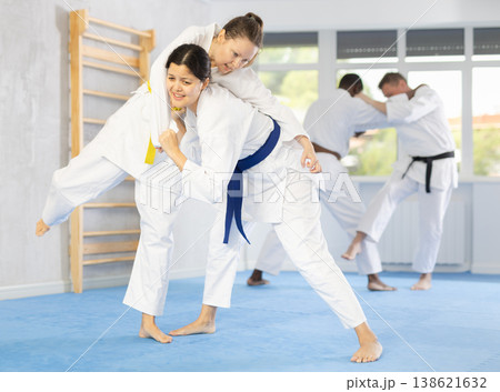 Girl tapping woman out with jiu jitsu grappling submission in gym 138621632