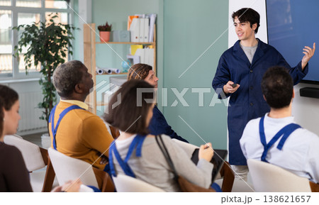 Male teacher conducts professional development lesson for workers Male teacher conducts professional development lesson for workers 138621657