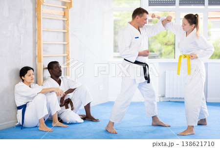 Adult man and adult woman train judo techniques Adult man and adult woman train judo techniques 138621710