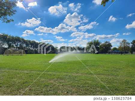 Football field irrigation. Irrigation turf. Sprinkler watering football field. System working football stadium. Automatic lawn sprinkler watering green grass. Water sprinklers watering soccer field 138623784