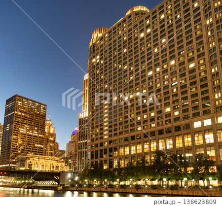 Business skyscraper at night. Skyscraper in city downtown. City architecture. Office building in business district. Modern glass building. Chicago night city. Night cityscape of Chicago skyscraper 138623809