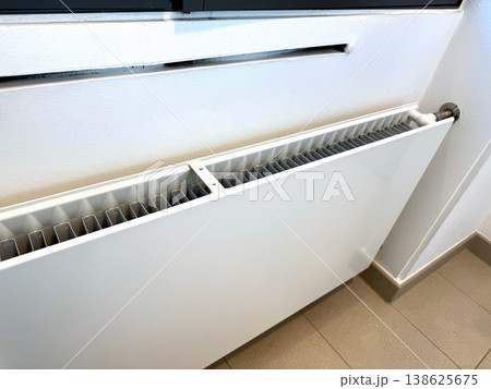 Modern Heating Radiator Close Up Indoors, Home Temperature Control and Energy Efficiency Concept. Modern Heating Radiator Close Up Indoors, Home Temperature Control and Energy Efficiency Concept. 138625675
