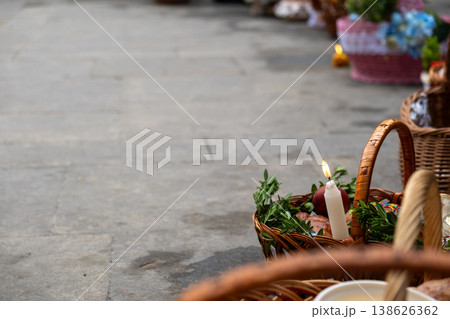 Easter food baskets with candles and flowers at blessing ceremony 138626362