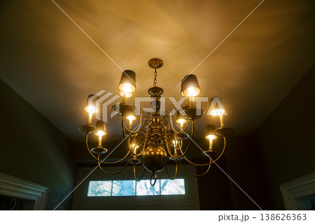 Charming Brass Chandelier Provides Soft Lighting In Cozy Home Setting Charming Brass Chandelier Provides Soft Lighting In Cozy Home Setting 138626363