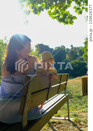 Mother and Child Enjoying a Sunny Day in the Park Mother and Child Enjoying a Sunny Day in the Park 138626377