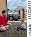 Father and toddler drawing with sidewalk chalk outdoors 138626433
