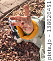 Child Sitting on Gravel with Sneaker and Jacket 138626451