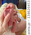 Close-up of newborn baby feet held in parents hand 138626453