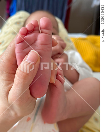 Close-up of newborn baby feet held in parents hand Close-up of newborn baby feet held in parents hand 138626453