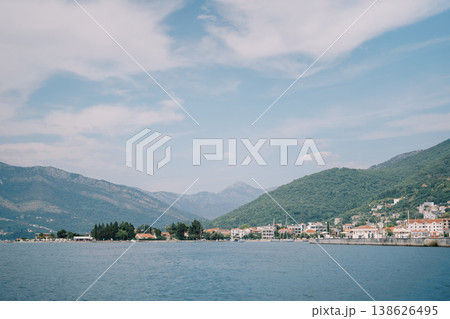 Serene Coastal Scenery. Calm Ocean View With Mountains And Village Scenes 138626495