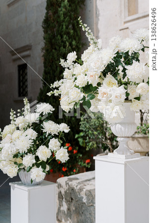 Romantic Floral Arrangements Enhancing Outdoor Villa Wedding Ambiance Romantic Floral Arrangements Enhancing Outdoor Villa Wedding Ambiance 138626496