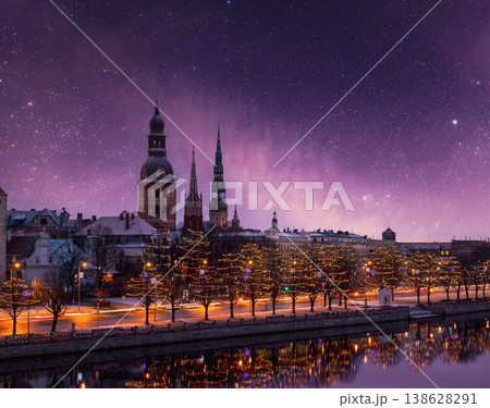 Illuminated Old Riga skyline over the Daugava River under a starry winter night sky 138628291