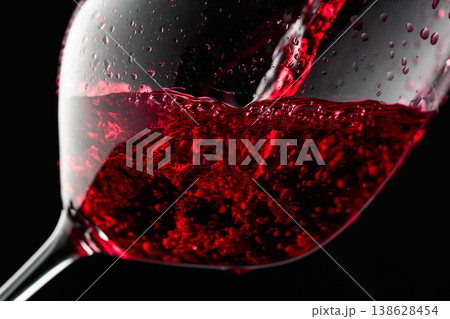 Red wine is poured into a glass. 138628454