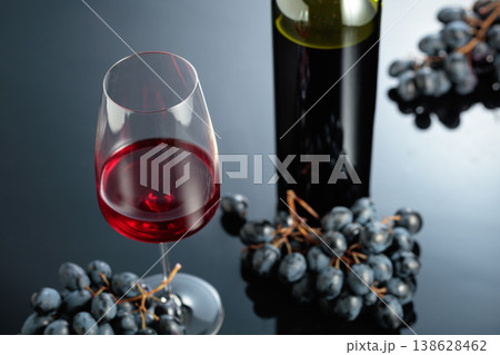 Red wine and juicy blue grapes. 138628462