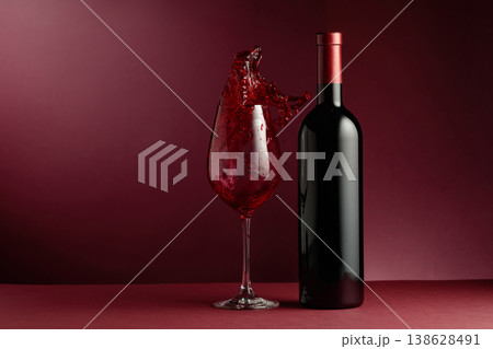 Red wine on a dark red background. 138628491