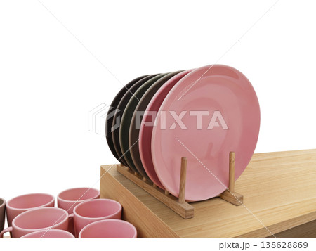 A clean dish rack sits on a wooden table against a white background. A clean dish rack sits on a wooden table against a white background. 138628869