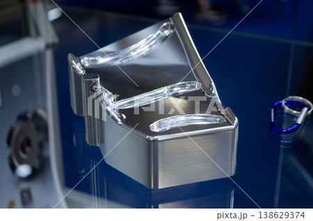 Metal part manufactured using CNC machining. Metal part made by metalworking CNC machine from a solid piece of metal. Polished aluminum or stainless steel. High-precision milling followed by polishing Metal part manufactured using CNC machining. Metal part made by metalworking CNC machine from a solid piece of metal. Polished aluminum or stainless steel. High-precision milling followed by polishing 138629374