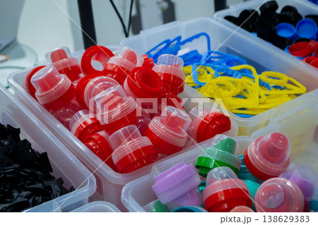 Different plastic products. Products made of multi-colored plastic. Models set of various products made of plastic. Multicolored objects. Models plastic bottle caps for sealing containers 138629383