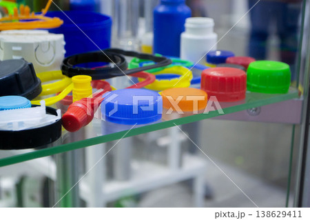 Different plastic products. Products made of multi-colored plastic. Models set of various plastic products made of plastic. Multicolored objects. Multicolored bottle caps 138629411