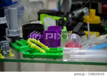 Different plastic products. Products made of multi-colored plastic. Models set of various plastic products made of plastic. Multicolored objects. 138629429