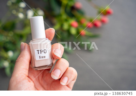 TPO free gel nail polish lying on a table in soft natural light. Highlighting clean beauty choices and awareness of Trimethylbenzoyl Diphenylphosphine Oxide in cosmetics 138630745