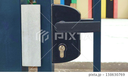 Door lock on an iron metal gate fence made of rods Door lock on an iron metal gate fence made of rods 138630769
