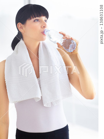 Drinking water, fitness and woman with wellness, tired and exercise with hydration, towel and sports. Person, healthy girl and athlete with liquid, aqua and workout with training, thirsty and fatigue Drinking water, fitness and woman with wellness, tired and exercise with hydration, towel and sports. Person, healthy girl and athlete with liquid, aqua and workout with training, thirsty and fatigue 138631108