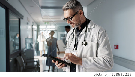 Doctor, hospital and tablet for medical information, typing and management of online charts or results. Healthcare worker, man or expert with digital technology for health services, planning and data 138631213