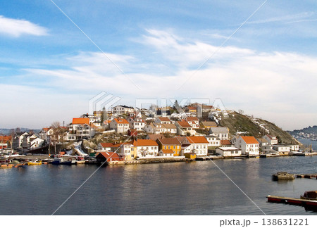Island, water and houses at ocean in Norway, Europe and tourism, travel or vacation. Exterior, home and Scandinavian buildings at sea, vintage architecture or traditional property with boats at port 138631221