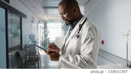 Doctor, hospital and tablet of healthcare information, typing and management of online charts or results. Healthcare worker or african person smile for service, planning or data on digital technology Doctor, hospital and tablet of healthcare information, typing and management of online charts or results. Healthcare worker or african person smile for service, planning or data on digital technology 138631307