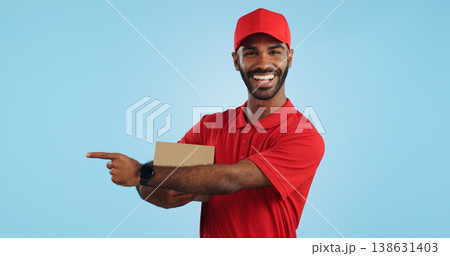 Advertising studio smile, delivery man and point at supply chain commercial, discount export info or distribution schedule. Courier service deal, mockup space and portrait person on blue background Advertising studio smile, delivery man and point at supply chain commercial, discount export info or distribution schedule. Courier service deal, mockup space and portrait person on blue background 138631403